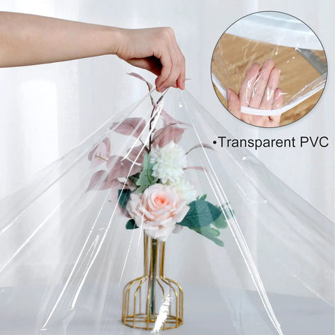 Transparent PVC vinyl table cover overlaying a floral arrangement to demonstrate material thickness and flexibility.