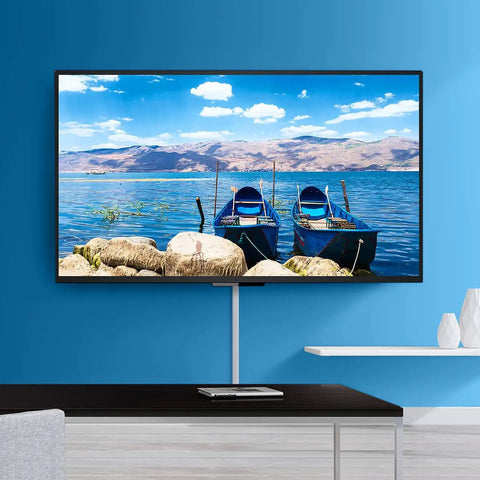 TV Cord Hider 42 Inch Cord Cover For Large Cable Management installed under wall-mounted TV on blue wall, concealing cables.