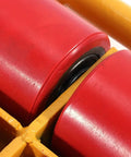 Close-up of heavy duty machinery skate swivel caster showing red roller and yellow frame for 12 ton load capacity.