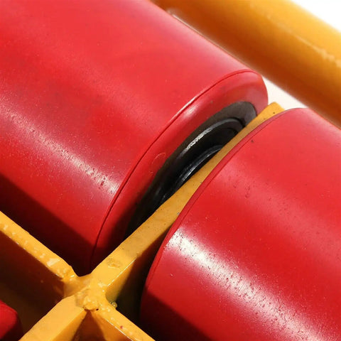 Close-up of heavy duty machinery skate swivel caster showing red roller and yellow frame for 12 ton load capacity.