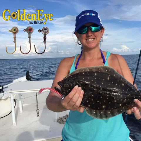 Angler holding flounder fish; GoldenEye One Eighth Ounce Jig Head For Inshore Fishing, Five Count Bag With Soft Plastic Lures.