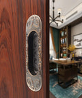 Close-up of Two Pack 4.13 Inch European Recessed Flush Pull Handle in Stainless Steel with Antique Copper Finish on wooden cabinet.