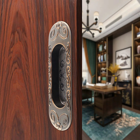 Close-up of Two Pack 4.13 Inch European Recessed Flush Pull Handle in Stainless Steel with Antique Copper Finish on wooden cabinet.