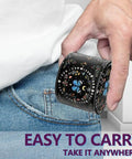 Black Manual Spice Grinder For Kitchen Use with a decorative design being placed in a pocket for easy portability.