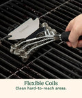Triple Coil Grill Brush 17 Inch Stainless Steel Bristle Free Scraper used on barbecue grate, close-up of flexible coils