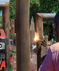 Rugged 110V 220V Stick Welder With 140 Amp Arc Output IGBT Inverter Digital LCD Display in use for welding metal pipes outdoors