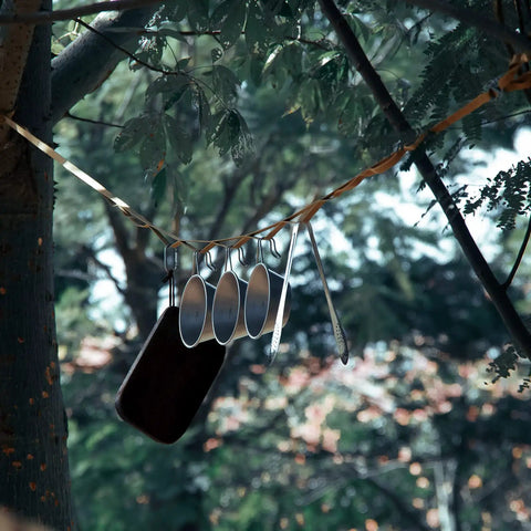 Heavy Duty Camping Lanyard Ten Feet With 19 Loops Daisy Chain Gear Hanger with cups and utensils in a forest setting