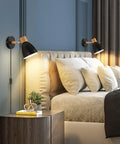 Plug In Swing Arm Wall Sconce Set Of Two Dope Black Bedside Reading Lamps With Cord And On Off Switch Adjustable Arm And Head Wall Mounted Lighting For Bedroom Hallway Modern Home Decor, installed above bed with cushions.