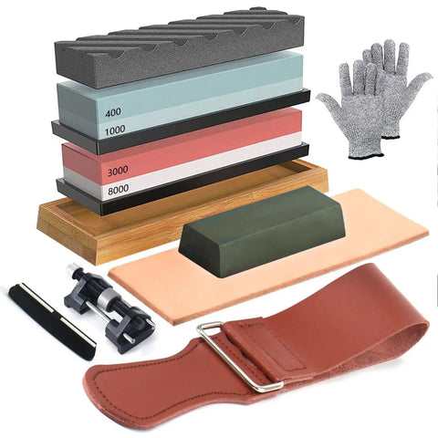 Go To Knife Sharpener Stone Set With Four Grit Waterstones 400 1000 3000 8000 Non Slip Bamboo Base Leather Razor Strop And Leather Honing Strop Angle Guide Honing Guide Polishing Compound Cut Resistant Gloves in full view showing sharpening stones, bamboo base, leather strop, and safety gloves.
