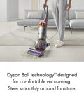 Man using Ball Animal 3 Extra Upright Vacuum With Pet Tools And Tangle Free Turbine Groom Tool on living room carpet