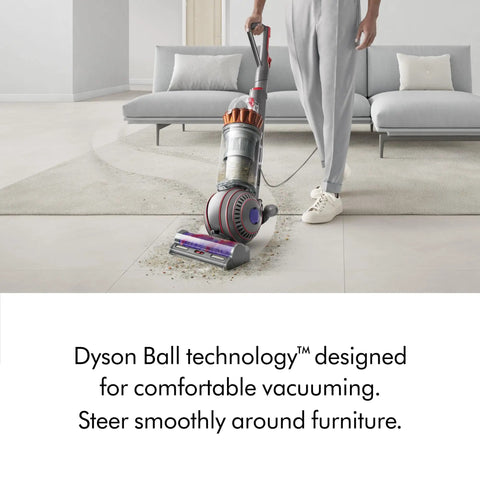 Man using Ball Animal 3 Extra Upright Vacuum With Pet Tools And Tangle Free Turbine Groom Tool on living room carpet