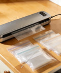 4 Piece Nichrome Heating Strip Replacement For Vacuum Sealer Machine 337mm Seal Element Bar, used with plastic food bags on countertop.