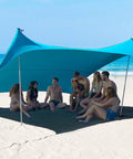Group enjoying shade under Ten By Ten Foot UPF50 Plus Beach Tent Sun Shelter Windproof Outdoor Pop Up Shade Canopy on beach