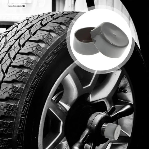 4 Pack Trailer Wheel Hub Bearing Rubber Caps With Water Protection shown beside trailer tire and hub