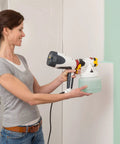 Woman using PaintReady Handheld HVLP Sprayer With ISpray Nozzle For Medium Sized Projects Delivers Roller Like Finish On Walls And Ceilings