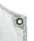 Close-up of light blue cotton denim with metal grommet detail on Denim Tool Shop Apron For Hairstylists With Five Pockets, Cross Back Straps.
