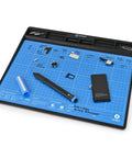 Magnetic FixMat Electronics Repair Mat With Dry Erase Grid And Sorting Bins displaying organized small parts on blue surface.