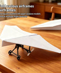 RC Paper Airplane Kit With Gyro Stabilizer For Beginners And Hobbyists DIY Electric Remote Control Plane on wooden table