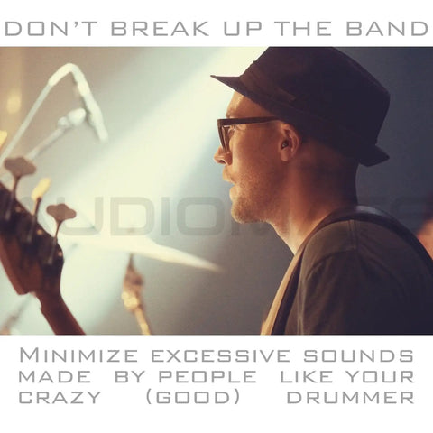 Musician wearing hat and glasses playing guitar on stage, emphasizing High Fidelity Earplugs With Metal Keychain Case And Two Interchangeable Earbuds.