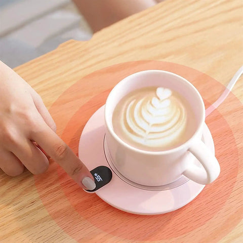 Slick Aluminum Coffee Cup Warmer With Smart Touch Controls And Automatic Shutoff Keeps Your Daily Brew Piping Hot At Fifty Five Degrees Zero Stress Compact Heated Desk Coaster in use with a latte.
