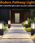 Modern Outdoor Bollard Pathway Lights Rock Solid Black Aluminum Yard Walkway Lamps with Waterproof White Glass illuminating a garden path.