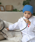 Child in Kid Friendly Doctor Costume Set With Lab Coat Scrubs Real Stethoscope 7 Piece Dress Up Kit examining dog