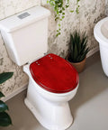 Round Bright maroon deep red colored cracked effect wall Toilet Seat on a white toilet, showcasing sturdy resin construction.