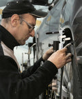 Person using DIY Auto Body Dent Repair Kit With Wheel Arch Marker And Iron Tool For Sheet Metal Restoration on car