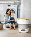 Slick Collapsible Mini Washing Machine With 13L Spin Basket And Quick Flip Design next to woman and child in modern kitchen.