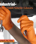 Two orange nitrile gloves with diamond grip gripping metal wrenches