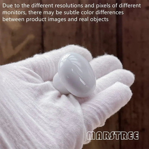 White Ceramic Cabinet Knobs Set Vintage Round Drawer Pull Handles For Kitchen Cabinets Dressers Wardrobes And Closets Includes Long And Short Screws For Easy Install Durable And Stylish For A Slick Upgrade. White ceramic round cabinet knob in gloved hand, 1.26-inch size