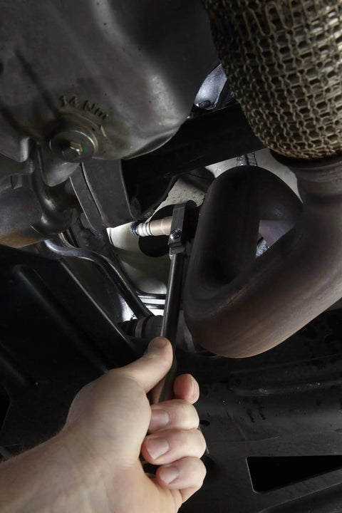 Flexible Head O2 Sensor Wrench For 7/8 Inch Sensors With Pivoting Design And Extended Reach To Grab Tough To Reach Seized Oxygen Sensors In Tight Engine Bays For Auto Repair Pros And DIY Enthusiasts on an O2 sensor under a car
