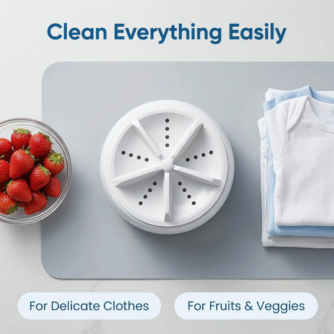 Portable Mini Ultrasonic Washing Machine For Everyday Laundry And Kitchen Prep This Compact Auto Cycle Device, top view with strawberries and folded clothes.
