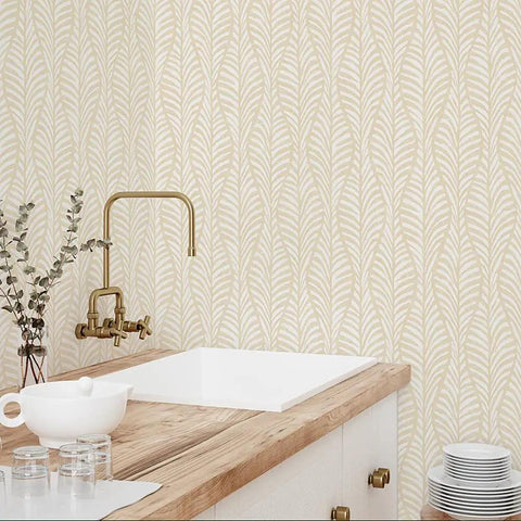 Removable Peel And Stick Wallpaper With Beige Block Print Leaves On Off White in a kitchen setting, featuring a gold faucet and sink