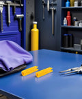 Five Piece Grease Fitting Tool Set With Ergonomic Handle And Plastic Zerk Cleaner on blue workbench in workshop