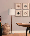 Lucas LED Floor Lamp With Drum Shade and Warm Wood Finish beside a wicker basket and modern decor in a cozy living room.