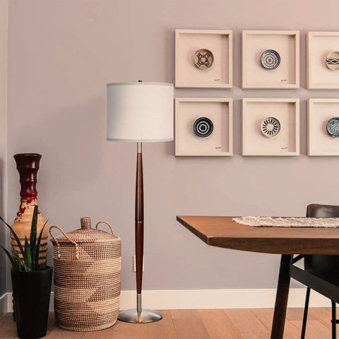 Lucas LED Floor Lamp With Drum Shade and Warm Wood Finish beside a wicker basket and modern decor in a cozy living room.