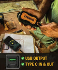 Heavy Duty Portable Charger Power Bank With IP67 Dust And Water Resistance, 10000 mAh Battery Pack held at a construction site