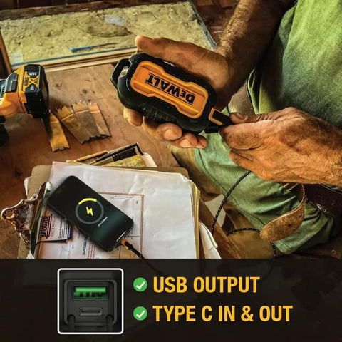 Heavy Duty Portable Charger Power Bank With IP67 Dust And Water Resistance, 10000 mAh Battery Pack held at a construction site