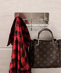 Heavy Duty Wall Mounted Adhesive Free Suction Hooks With Rock Solid Air Pressure Grip holding a red plaid jacket and a patterned handbag.