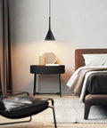 Bedroom scene with Industrial Adjustable Pendant Light Matte Black 3 Lamp Dope Retro Vibe Vintage Cone Fixture over nightstand.