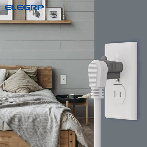 Bedroom scene with 2 To 3 Prong Adapter And 3 To 2 Prong Converter Set 10 Pack Indoor Gray Outlet Adapters plugged in beside bed.