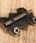 Close-up of a hinge from the 20 Piece Butt Hinge Set With Screws In Antique Bronze Finish For Wooden Jewelry Boxes Cabinets Doors And Wine Cases 25 By 20 mm Solid Built To Last Vintage Style Hardware