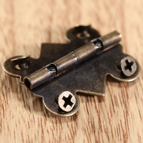 Close-up of a hinge from the 20 Piece Butt Hinge Set With Screws In Antique Bronze Finish For Wooden Jewelry Boxes Cabinets Doors And Wine Cases 25 By 20 mm Solid Built To Last Vintage Style Hardware