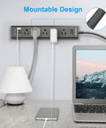 8 In 1 Surge Protector Power Strip With 5 Widely Spaced Outlets 3 USB Ports Including USB C Port 1250 Watt 10 Amp 5 Ft Extension Cord Wall Mountable For Home Office Black mounted on wall with laptop and lamp