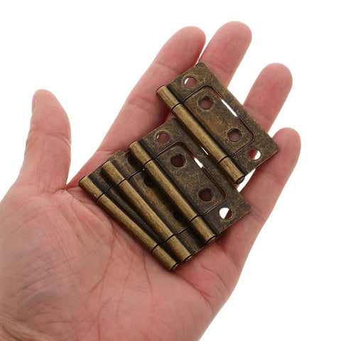 Heavy Duty Iron Hinge Set For Cabinets And Interior Wood Doors With Quiet Operation Vintage Style Perfect For Kitchen Cabinets RVs Campers And Trailer Furniture Hardware, close-up in hand