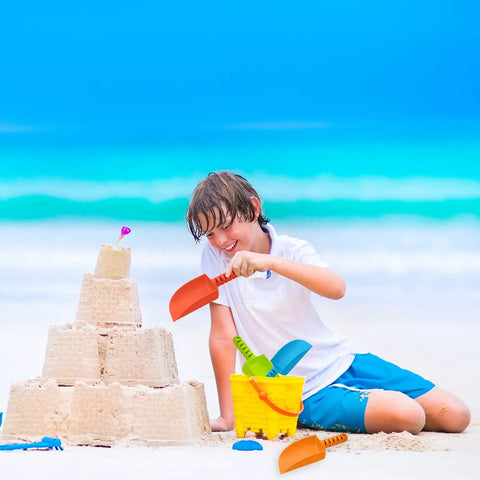 Boy playing with 4 Pack Beach Shovels For Kids 8 Inch Heavy Duty Plastic Sand Shovels next to sandcastle on beach