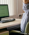Close-up of Undermount Keyboard Tray With Ergonomic Tilt And Clip Mount attached under a desk with a computer setup.