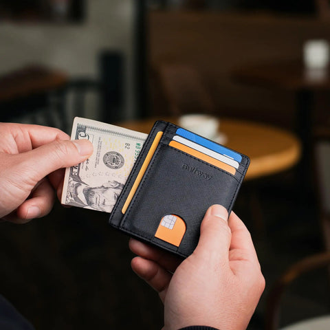 Dead Simple Minimalist Front Pocket Leather Wallet With Secure RFID Blocking For Men And Women Hella Slim Everyday Carry Low Build Cash And Card Organizer Cross Black Finish with cash and cards visible.