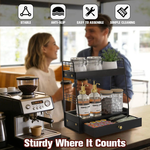 Coffee Bar Station Organizer with Built In Drawer and Two Tier Countertop Shelf for Tea Bags Coffee Accessories and Syrup Bottles Black Finish displayed on a kitchen counter.